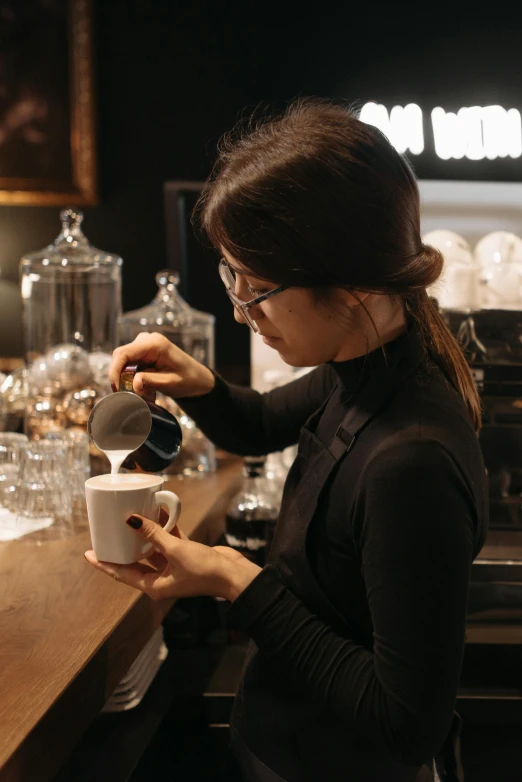 a woman is pouring a cup of coffee, taejune kim, carefully crafted, premium quality, at checkout