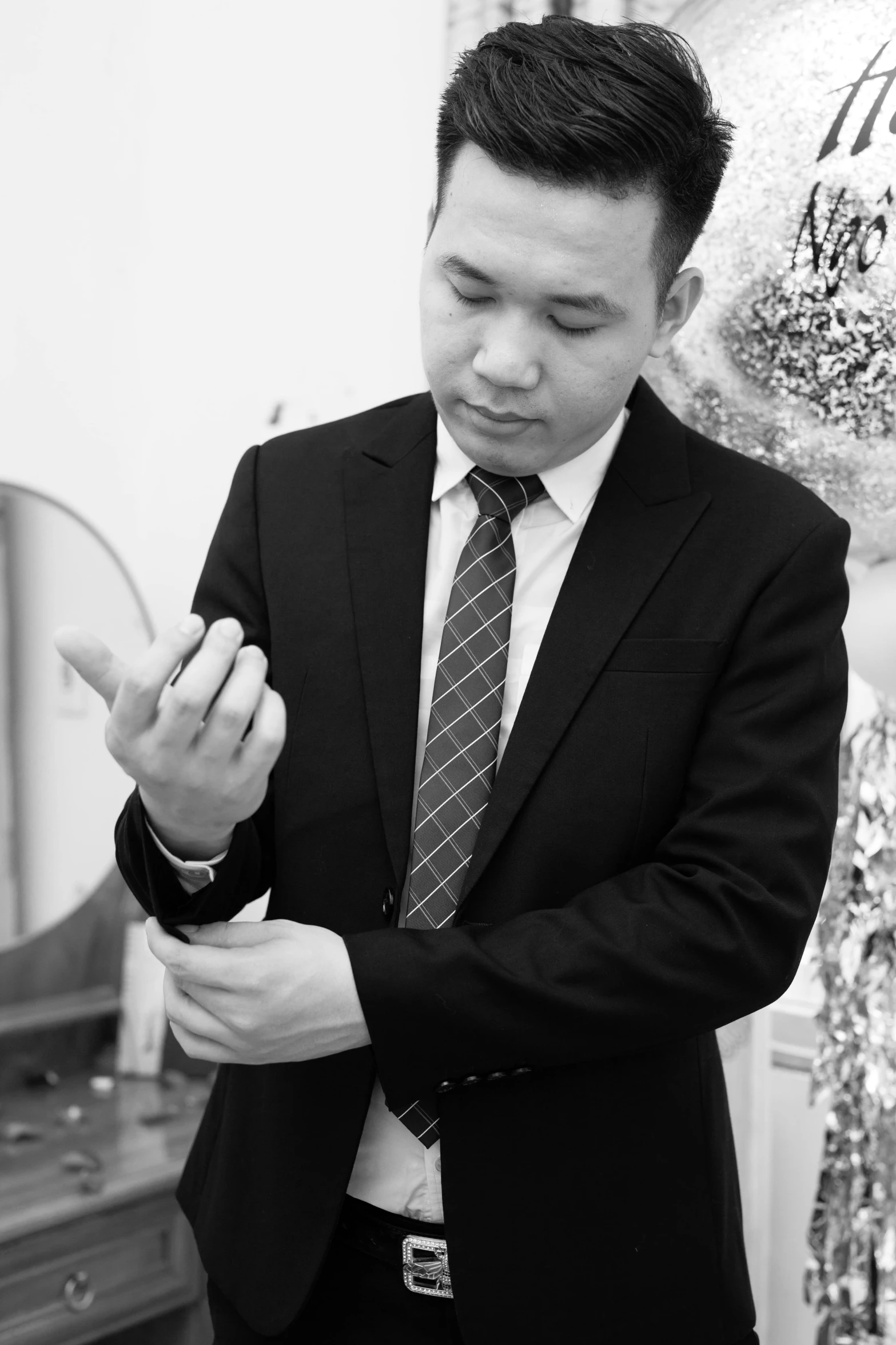 a man in a suit standing in front of a mirror, a black and white photo, inspired by Fei Danxu, gutai group, wedding, wearing jewelry, inspect in inventory image, professional profile picture