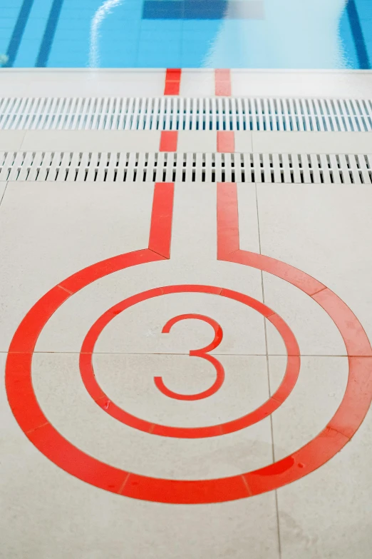 a swimming pool with the number 3 painted on it, inspired by Ian Hamilton Finlay, unsplash, graffiti, thin red lines, 3 - piece, calatrava, bus station