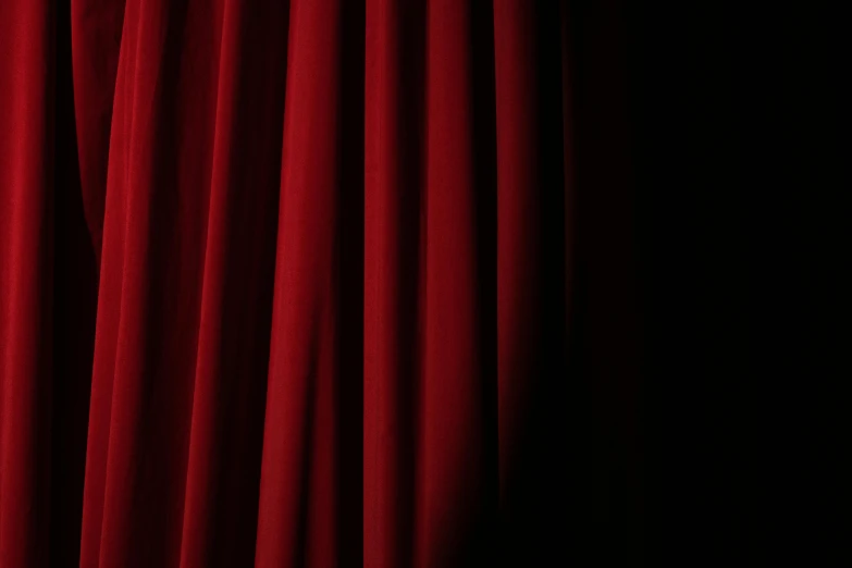 a close up of a red curtain with a black background, lights off, coated pleats, getty images, uniform background