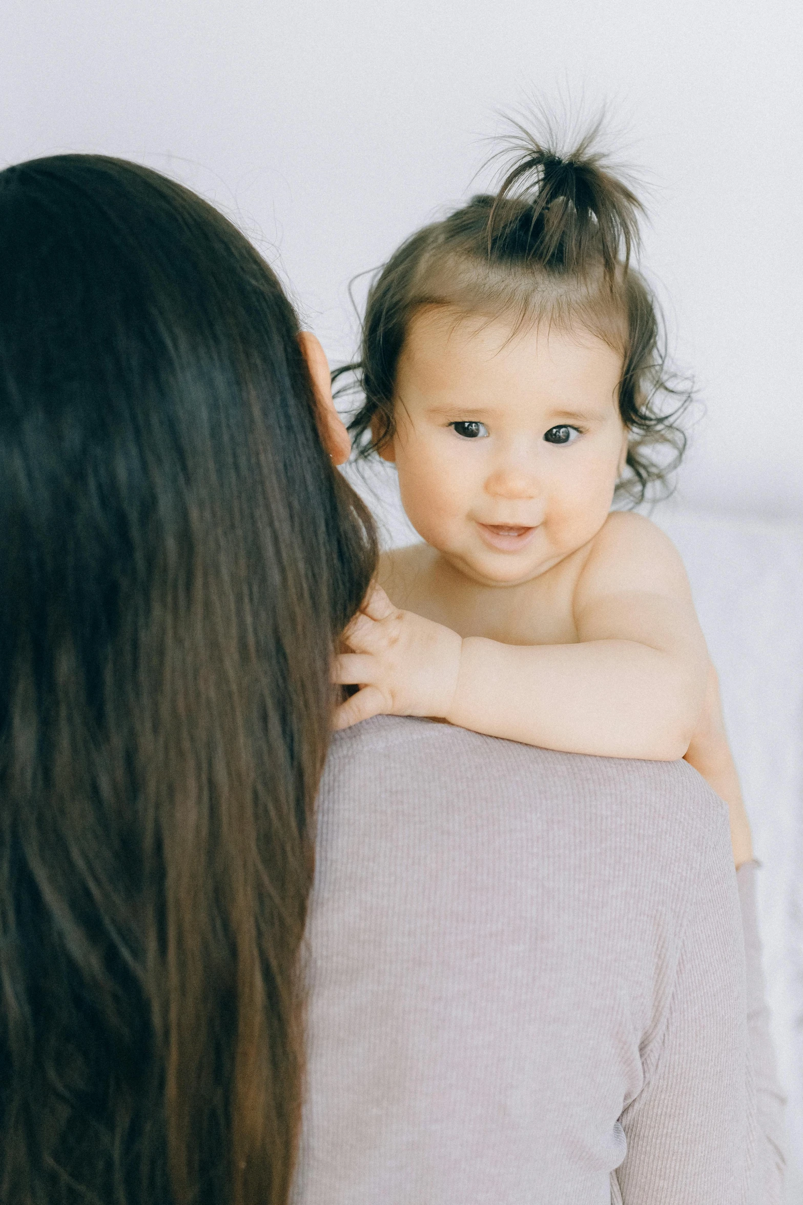 a woman holding a baby in her arms, pexels, girl with dark brown hair, banner, bedhead, manuka