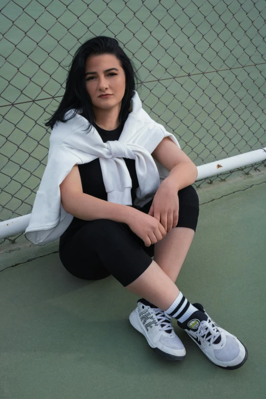 a woman sitting on top of a tennis court holding a racquet, an album cover, inspired by Ion Andreescu, featured on reddit, techwear clothes, tifa lockhart portrait, wearing white sneakers, ((portrait))