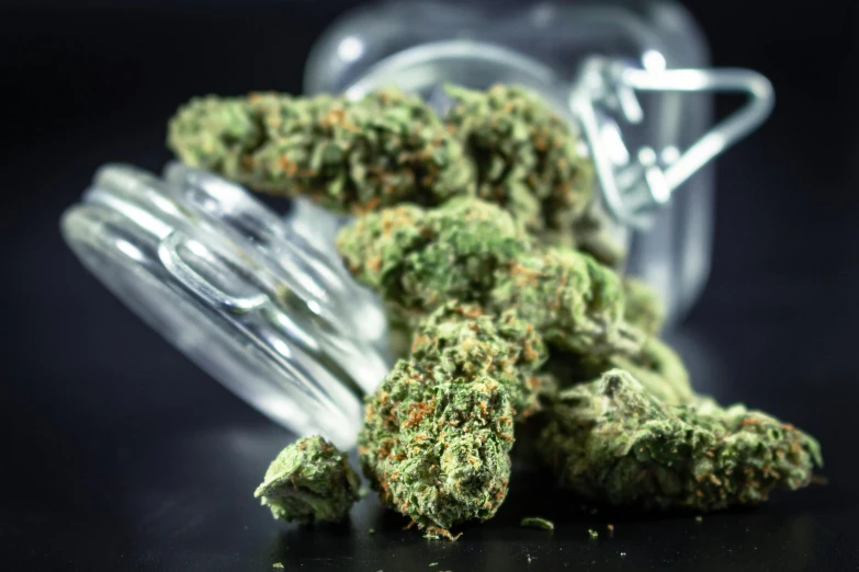 a jar of marijuana sitting on top of a table, pexels, hurufiyya, glass flowers, middle close up, thumbnail, digital image