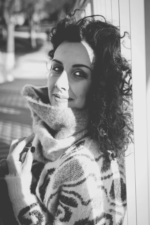 a black and white photo of a woman with curly hair, a black and white photo, inspired by Anita Malfatti, wearing a sweater, beautiful iranian woman, square, high quality upload