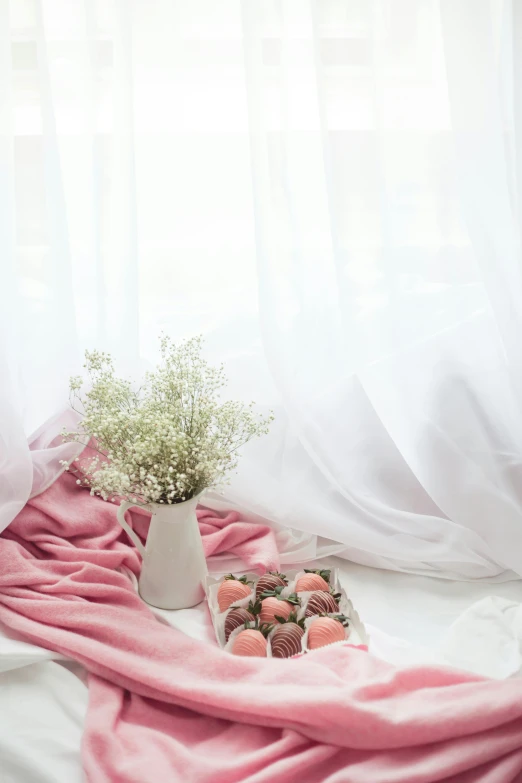 a tray of strawberries sitting on top of a bed, inspired by Ma Yuanyu, unsplash contest winner, romanticism, ethereal curtain, candies, soft studio lighting, white and pink cloth