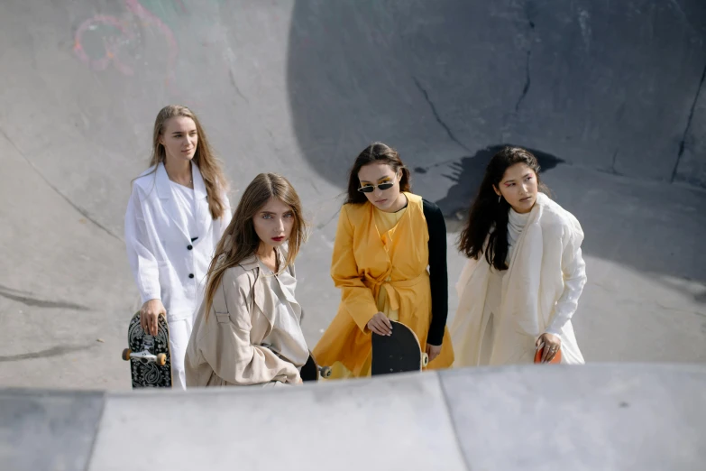 a group of women standing next to each other on a skateboard ramp, trending on pexels, gutai group, wearing a trenchcoat, photoshoot for skincare brand, off - white collection, circle