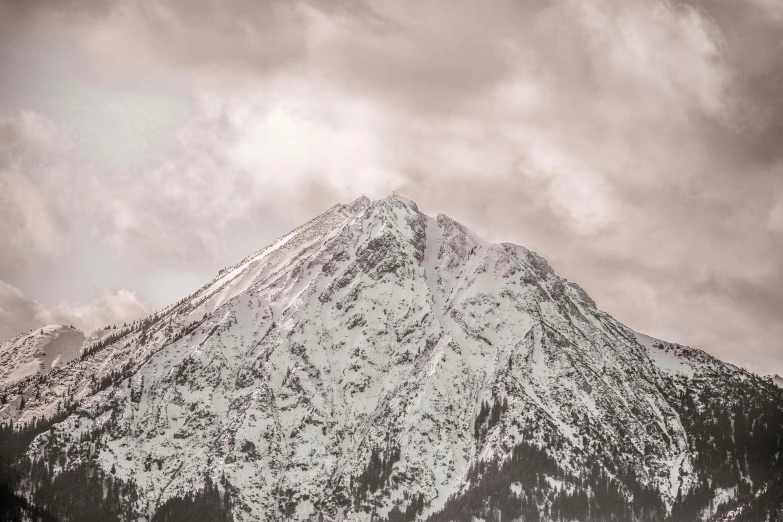 a black and white photo of a snow covered mountain, pexels contest winner, pink and grey muted colors, brown, low detailed, low-angle