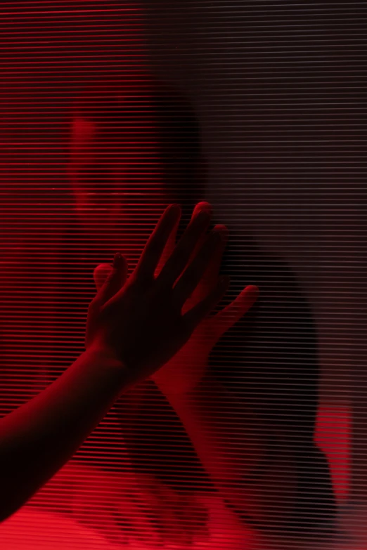 a person standing in front of a red light, hands hidden, darkwave, crawling out of a dark room, instagram post