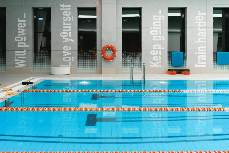 a swimming pool with a life preserver next to it, by Emma Andijewska, modernism, gray and orange colours, local gym, thumbnail, melbourne