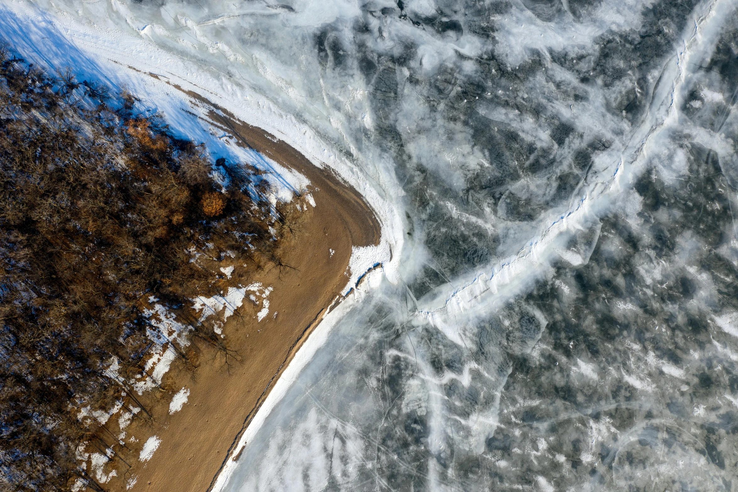 an aerial view of a road in the middle of a frozen lake, pexels contest winner, land art, thumbnail, shoreline, turbulent, minn