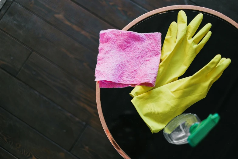 a pair of yellow gloves sitting on top of a table, green and pink, cleanest image, sweeping, circular