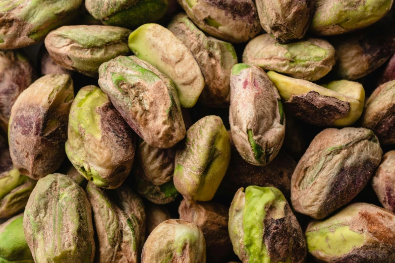 a pile of pistats sitting on top of each other, a portrait, trending on pexels, walnuts, pale green glow, chile, detailed product image