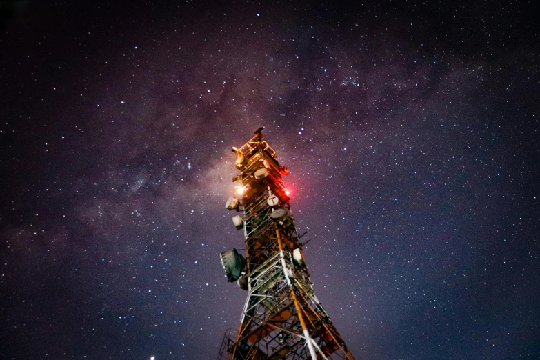 a very tall tower with a star filled sky in the background, unsplash contest winner, realism, radio equipment, multicoloured, ben ridgway, night sky; 8k