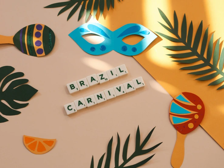 a couple of masks sitting on top of a table, by Amelia Peláez, pexels contest winner, carnival background, lettering, brazil, on a pale background