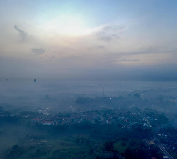 an aerial view of a city on a foggy day, pexels contest winner, sumatraism, hot air balloon, panorama view of the sky, bali, pale blue fog