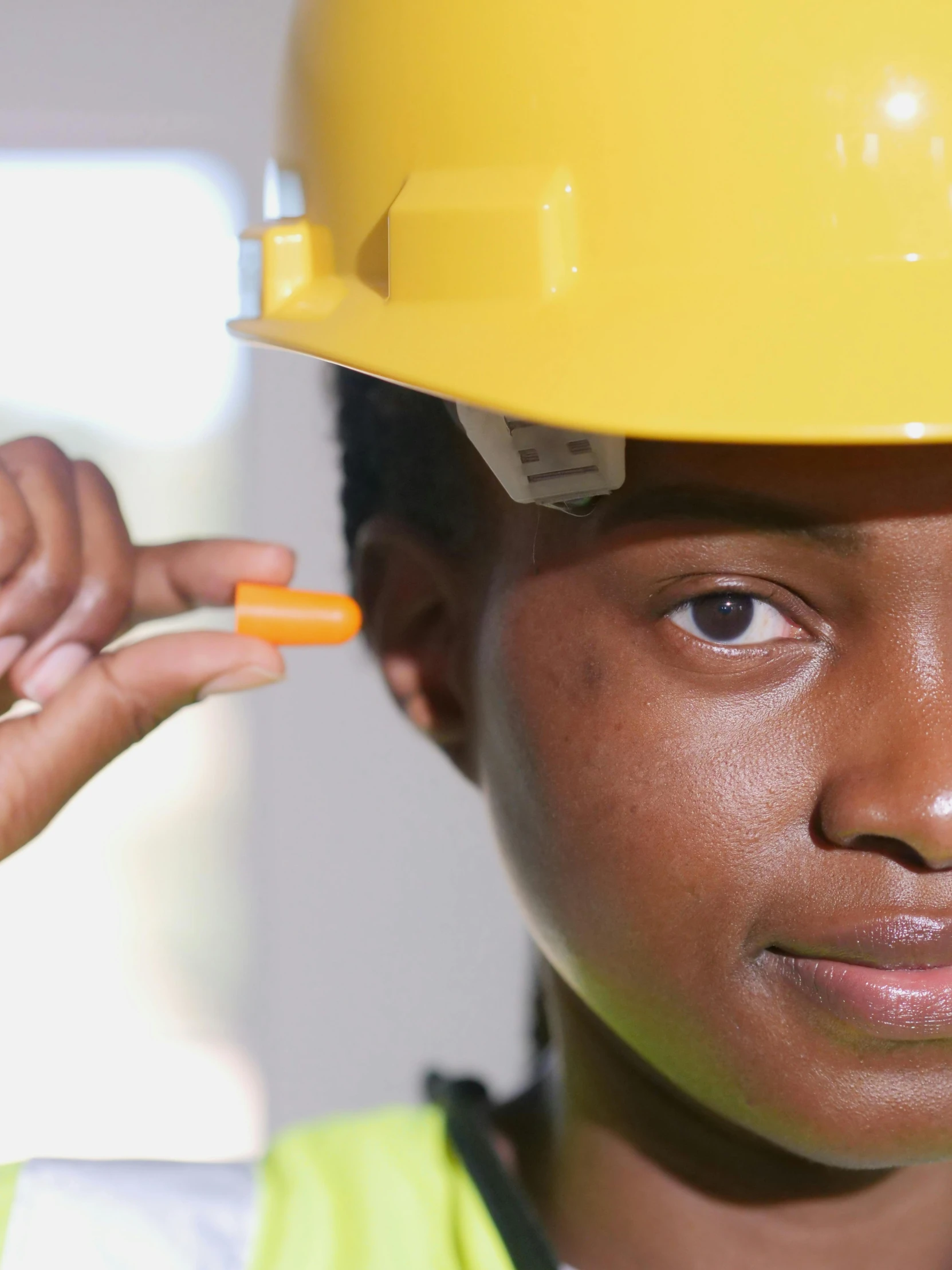 a close up of a person wearing a hard hat, a stock photo, inspired by Afewerk Tekle, looking her shoulder, nursing, sustainability, schools