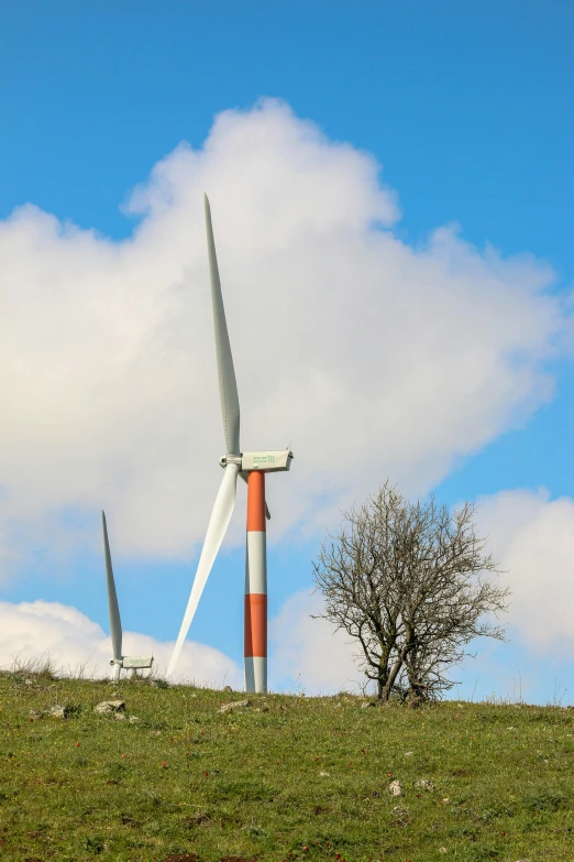 a couple of wind turbines sitting on top of a lush green hillside, by Jan Tengnagel, precisionism, no cropping, blue sky, mining, today\'s featured photograph 4k