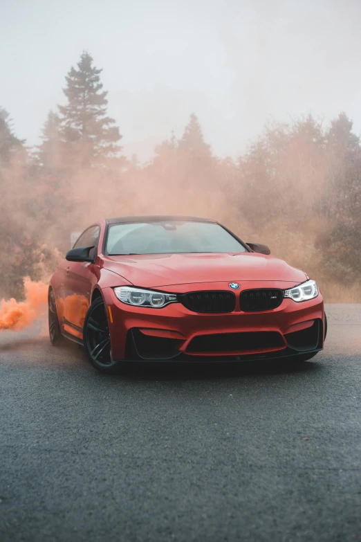 a red bmw car driving on a foggy road, pexels contest winner, colored smoke, frontal pose, performance, fire & smoke