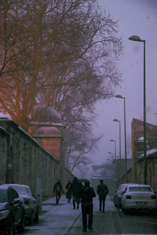 a group of people walking down a snow covered street, an album cover, inspired by Elsa Bleda, les nabis, mosque, grainy footage, turkey, low quality photo