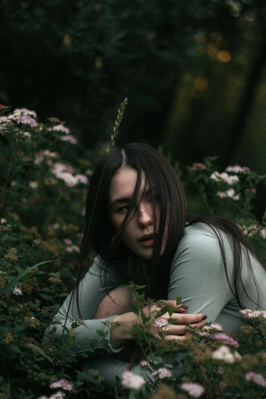 a woman sitting in a field of flowers, inspired by Elsa Bleda, pexels contest winner, renaissance, portrait of a ominous girl, portrait sophie mudd, with soft bushes, in green forest