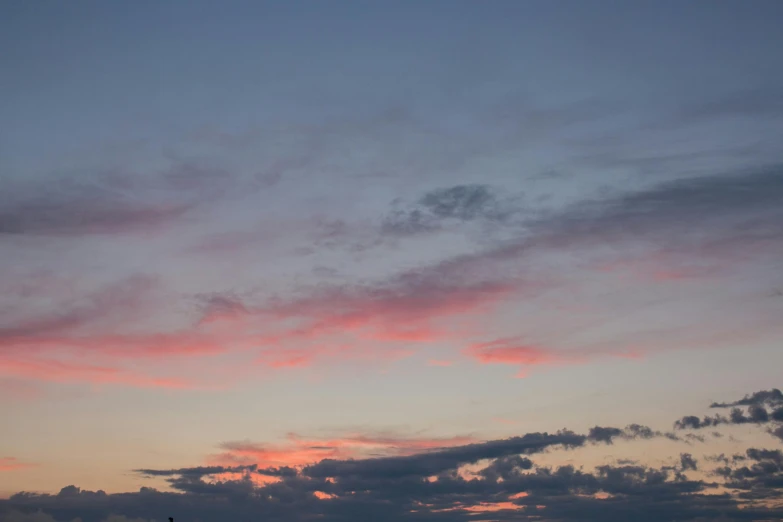 a couple of kites that are flying in the sky, unsplash, romanticism, at gentle dawn pink light, layered stratocumulus clouds, shot on sony a 7, summer night