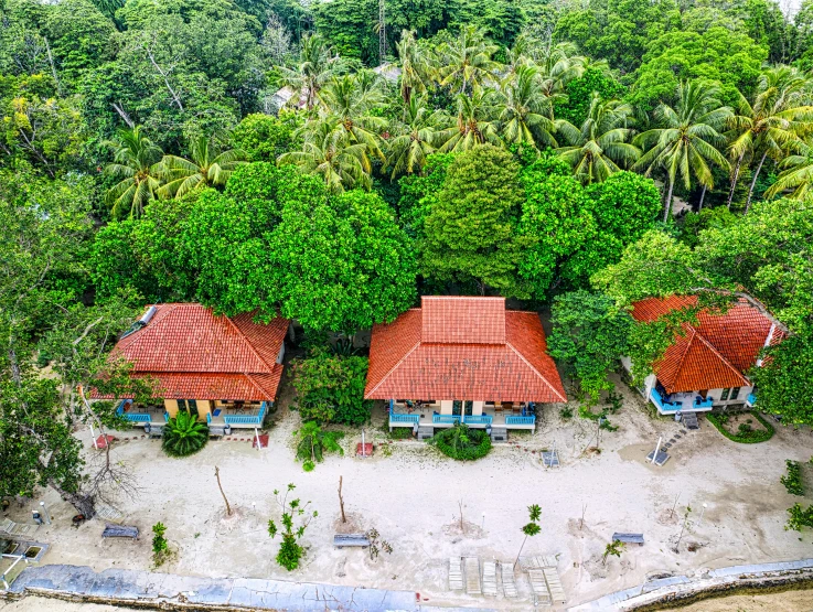 a couple of houses sitting on top of a sandy beach, in a jungle environment, flatlay, orange roof, exterior photo