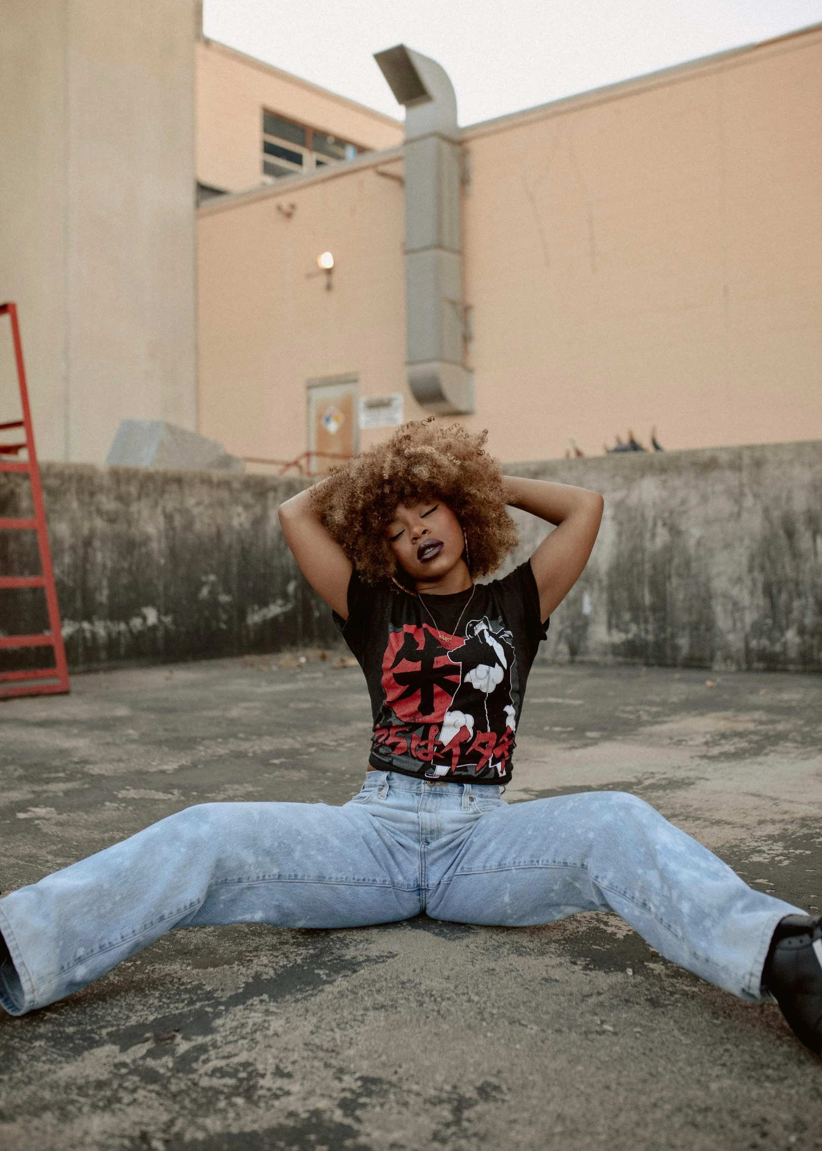 a woman sitting on the ground with her hands behind her head, an album cover, trending on pexels, black arts movement, kawaii shirt and jeans, eighties-pinup style, aggressive pose, wild ginger hair