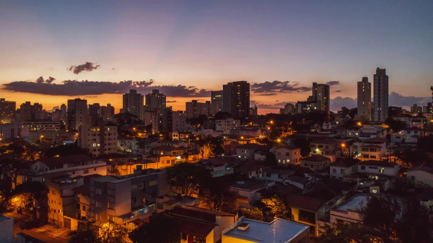 an aerial view of a city at night, a photo, by Luis Miranda, pexels contest winner, summer sunset, brazilian, late afternoon light, ultrawide lens”