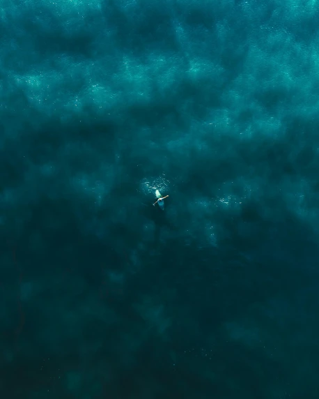 a person on a surfboard in the middle of a body of water, by Jacob Toorenvliet, pexels contest winner, not a messenger from above, deep blue atmosphere, 4k), 4 k )