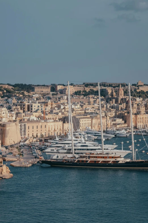 a large body of water filled with lots of boats, a photo, pexels contest winner, renaissance, mediterranean island scenery, three masts, skyline showing, black