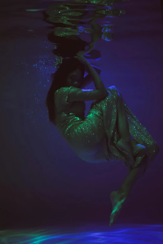 a woman in a green dress is under water, an album cover, inspired by Elsa Bleda, unsplash, nighttime, sza, showstudio, blue