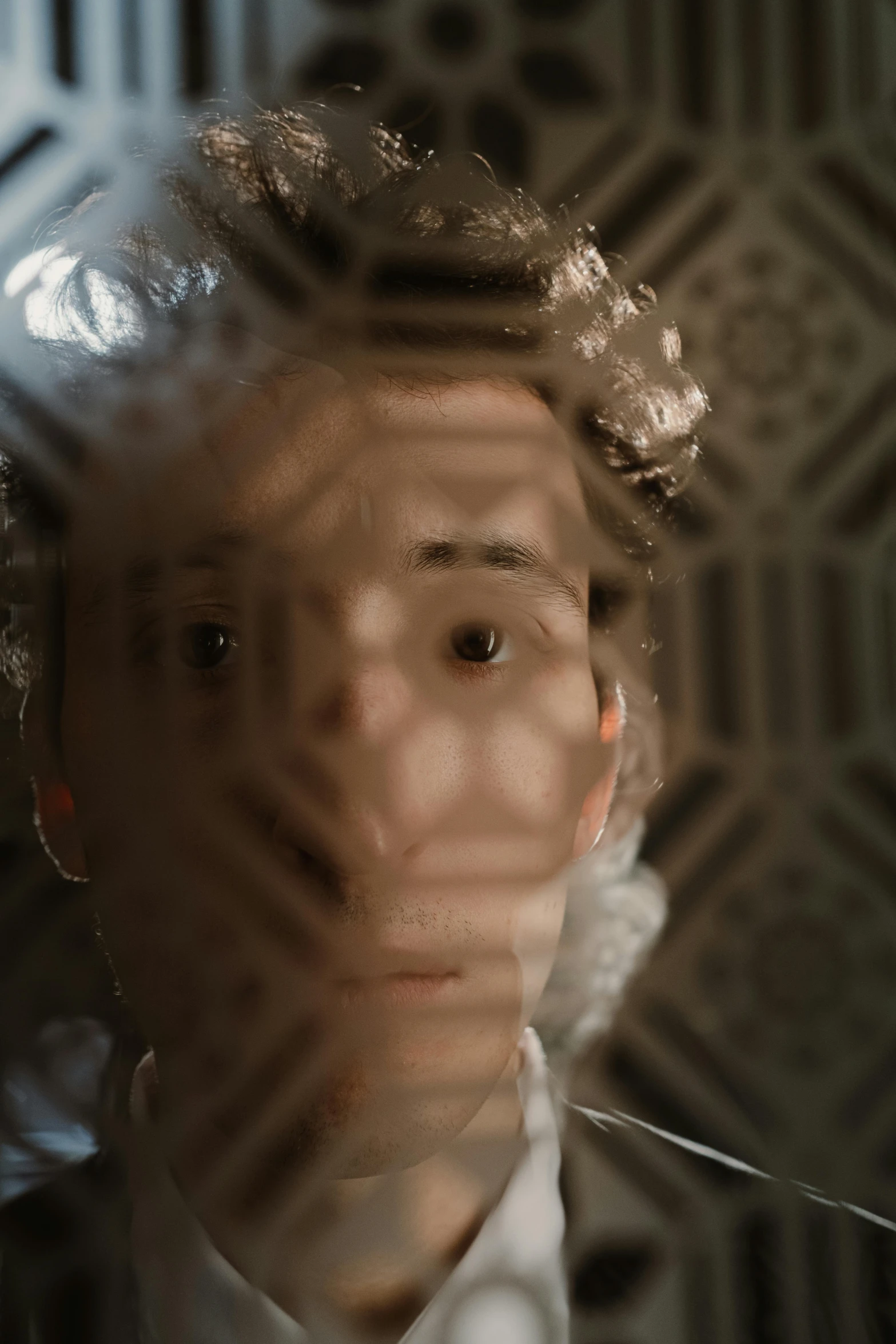 a close up of a person wearing a suit and tie, inspired by Anna Füssli, video art, portrait of timothee chalamet, looking through frosted glass, patterned, armor focus on face