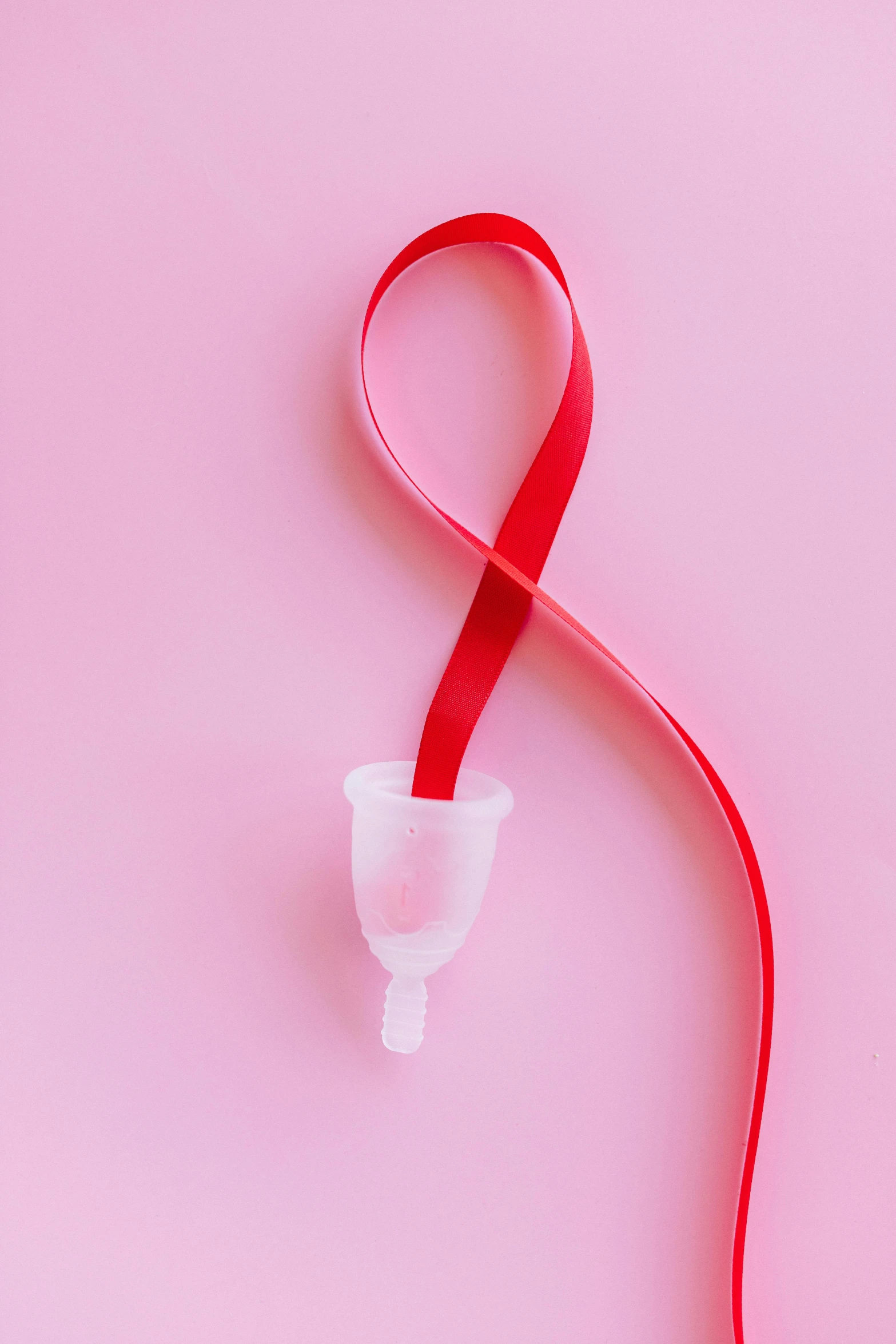 a red ribbon in the shape of a heart on a pink background, by Julian Allen, plasticien, with an iv drip, d-cup, official product image, red bra