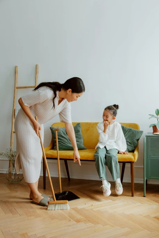 a woman and a little girl cleaning a living room, a colorized photo, pexels contest winner, minimalism, asian man, white broom closet, intense flirting, gardening