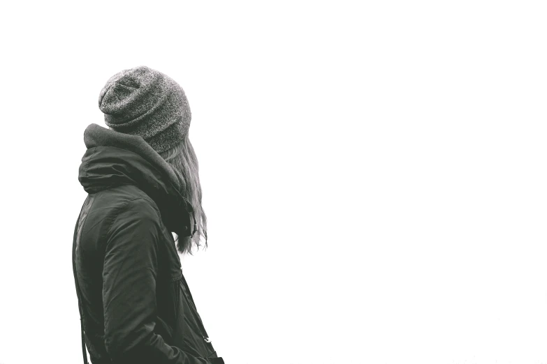 a black and white photo of a person wearing a hat, a black and white photo, pexels, minimalism, girl wearing hoodie, facing away, wintermute, set against a white background