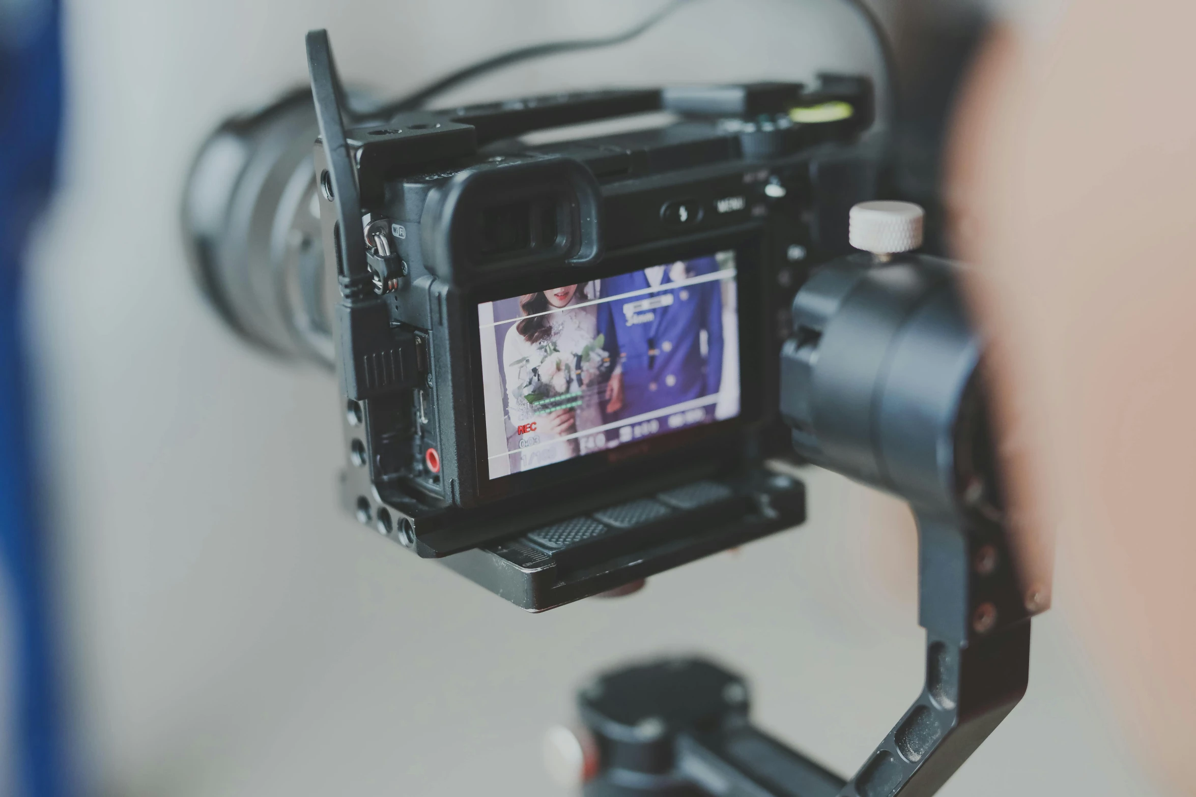 a close up of a camera on a tripod, unsplash, video art, streaming on twitch, film frame, lower quality, with back to the camera