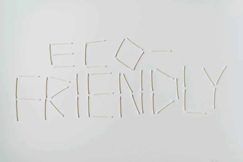 a white board with the words eco friendly written on it, an album cover, by Emma Andijewska, trending on pexels, wooden match sticks 4k texture, happy friend, concrete poetry, die antwoord