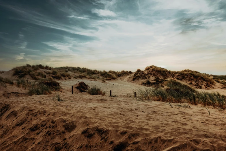 a sandy beach with a fence in the sand, an album cover, unsplash, baroque, thumbnail, multiple stories, frank moth, skies