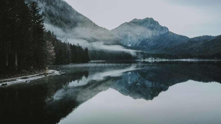 a body of water with a mountain in the background, pexels contest winner, grey forest background, mirrored, cold mist, 1 2 9 7