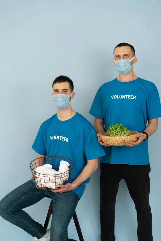 a couple of men standing next to each other, pandemic, cleanest image, confident holding vegetables, blue themed