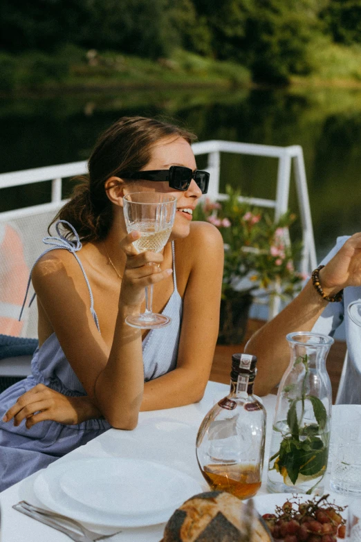 a couple of people that are sitting at a table, river of wine, with sunglasses, victoria siemer, clear and sunny