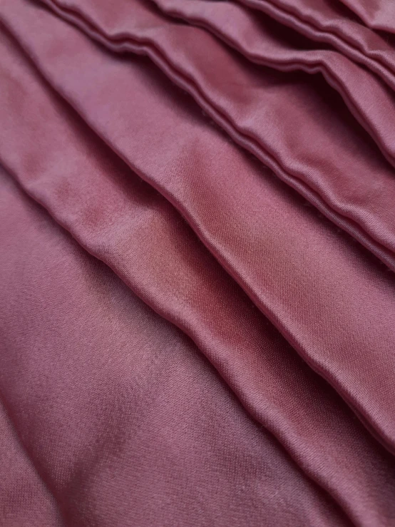 a close up of a bed with a purple comforter, red skintight leather armor, soft translucent fabric folds, taken on iphone 1 3 pro, detailed product image