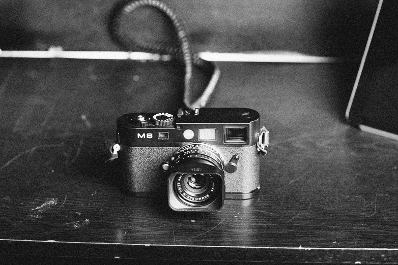 a black and white photo of a camera on a table, by Alexander Deyneka, cinematic. by leng jun, famous photograph