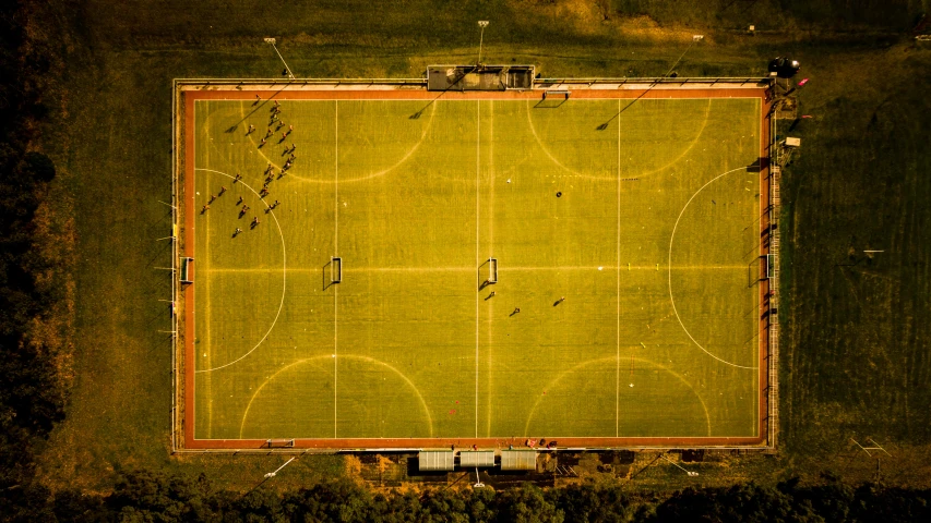 an aerial view of a soccer field at night, by Peter Churcher, unsplash contest winner, golden hour sunlight, concert, old school, helicopter view