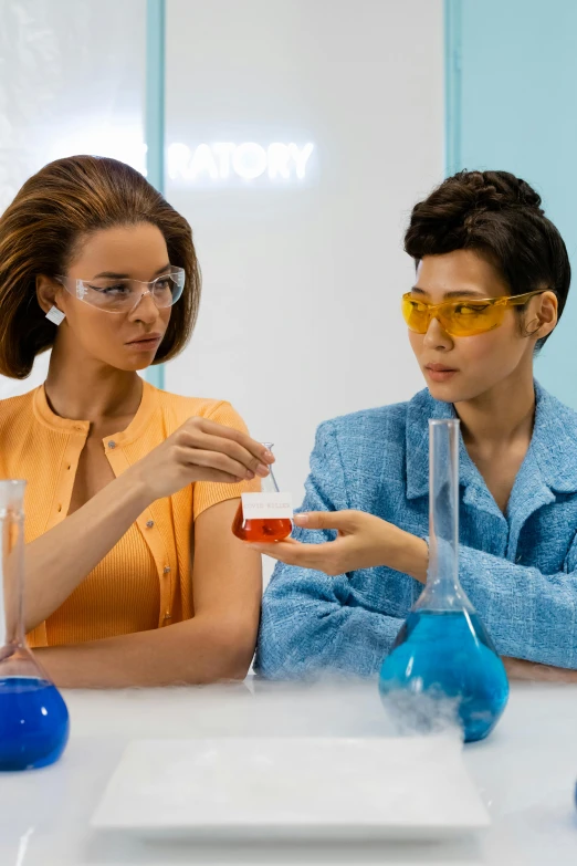 a couple of people that are sitting at a table, futuristic chemistry lab, lesbian, curated collections, amber glasses