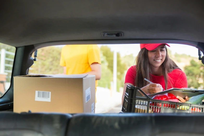 a woman with a shopping basket in the back of a car, a portrait, shutterstock contest winner, happening, wearing a red backwards cap, college students, serving happy meals, te pae