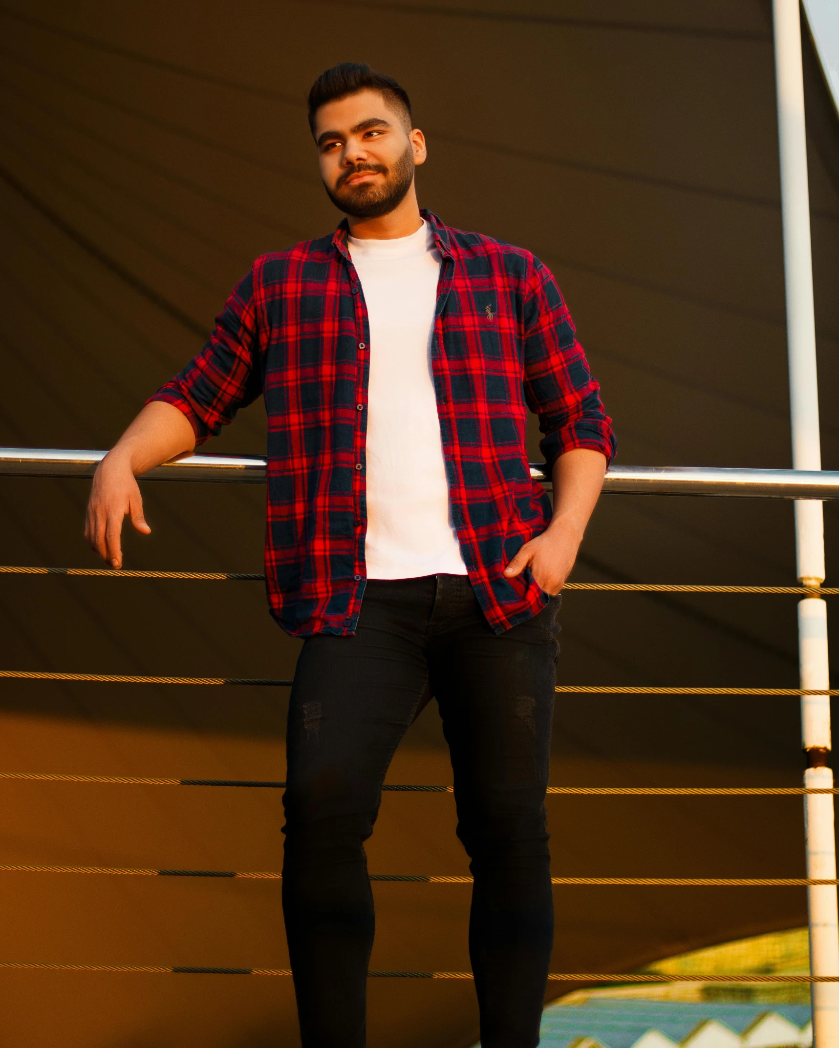 a man that is standing on a skateboard, by Adam Dario Keel, hurufiyya, wearing a plaid shirt, kyza saleem, light stubble with red shirt, official product photo