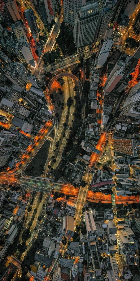 an aerial view of a city at night, an album cover, by Adam Marczyński, unsplash contest winner, dark grey and orange colours, sinuous, melbourne, mapbox