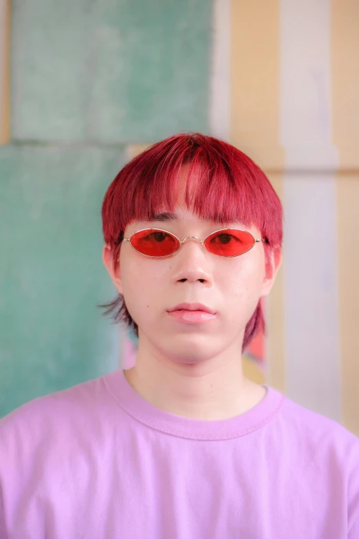 a woman with red glasses standing in front of a wall, an album cover, inspired by Yanjun Cheng, trending on pexels, bowl haircut, red dyed hair, headshot profile picture, oval eyes