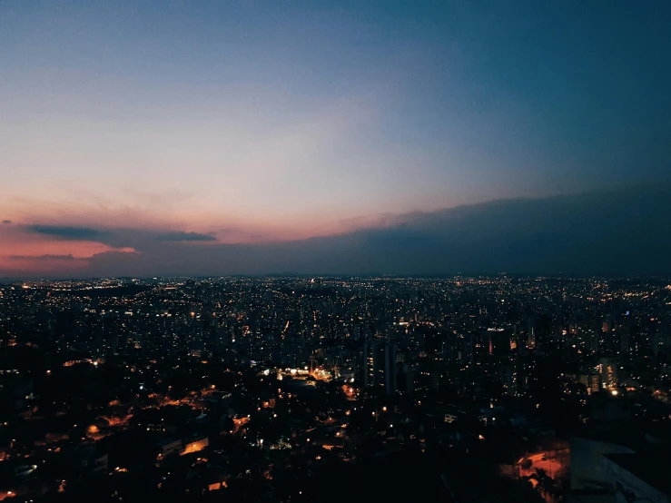 a view of a city at night from the top of a hill, inspired by Elsa Bleda, pexels contest winner, ☁🌪🌙👩🏾, são paulo, warm summer nights, looking partly to the left